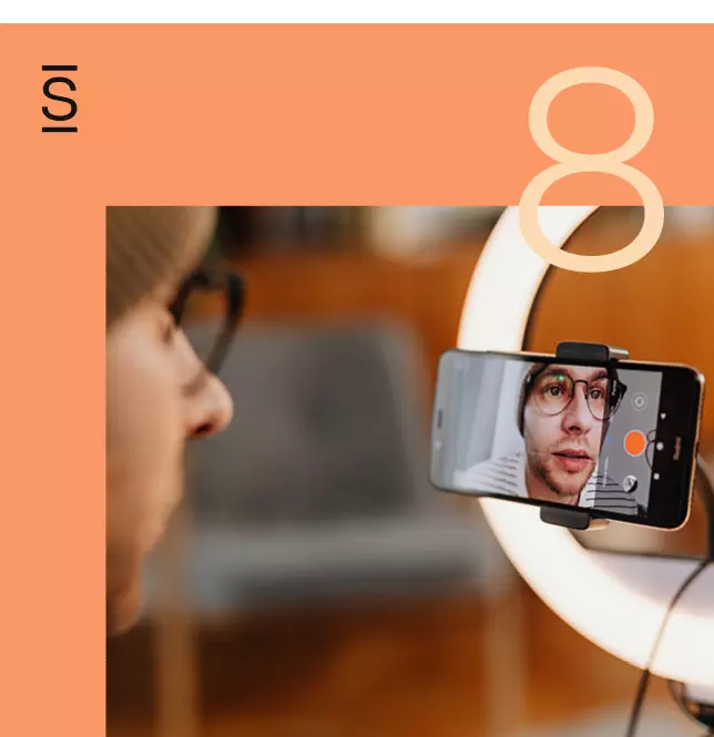 Intranet - man with glasses and beanie speaking into smartphone that is recording