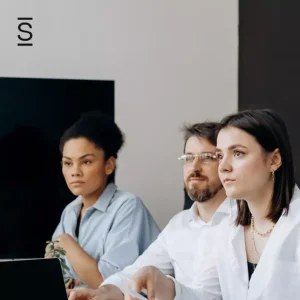 Internal communications - three employees looking at unseen speaker during a conference