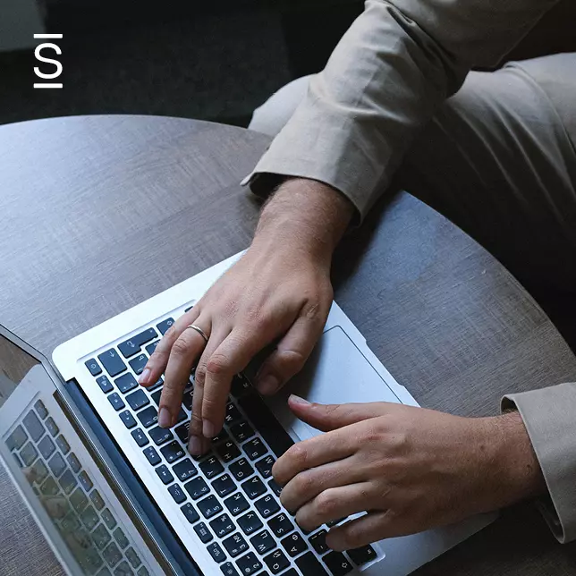 Corporate intranet - man using laptop on top of wooden table