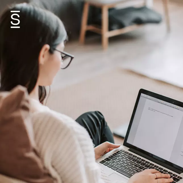 Work From Home - woman with glasses typing on laptop computer