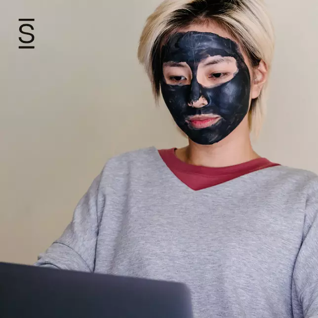 Keep Employees Motivated - woman wearing skincare mask and using laptop computer