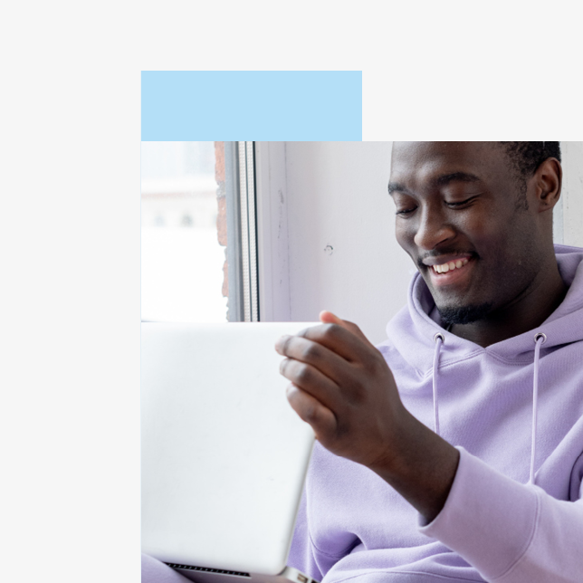 Employee experience - man in purple sweatshirt holding laptop computer