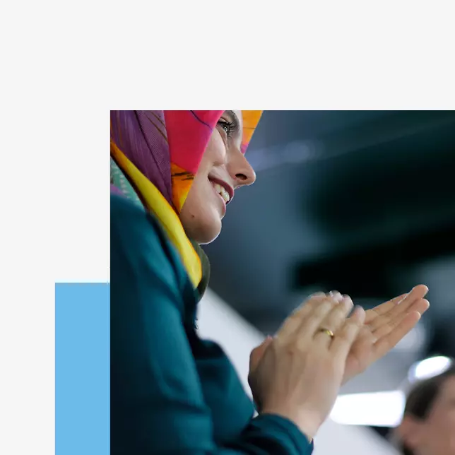 Employee engagement - woman in multi-colored hijab applauding