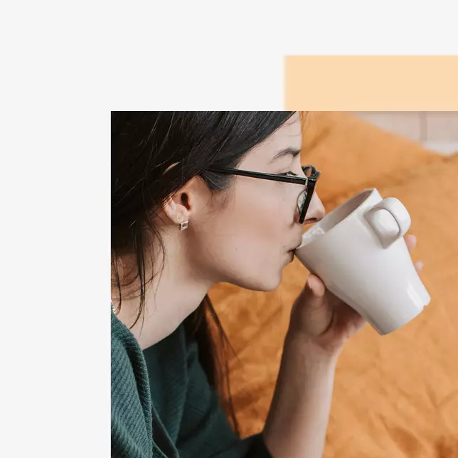 Employee satisfaction - woman with glasses drinking from a coffee mug