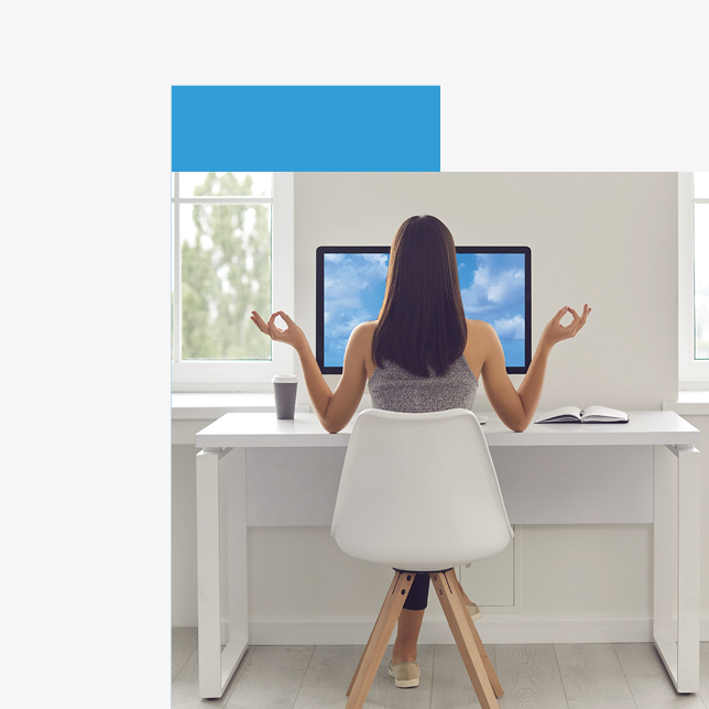 Employee wellness - woman sitting in front of computer while meditating