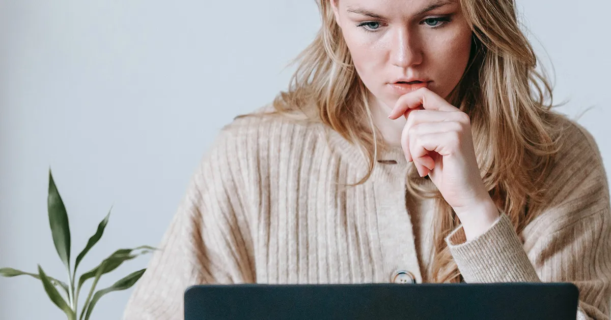 Intranet security - woman wearing sweater working on laptop computer