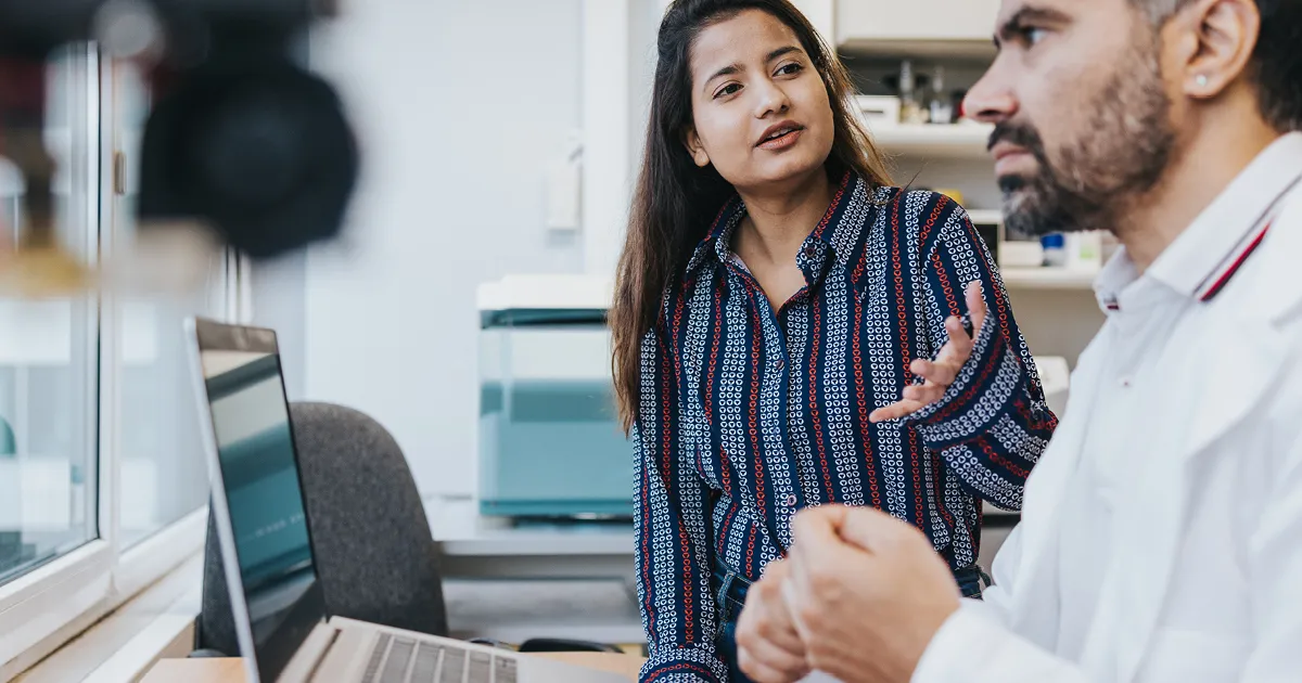 Empowering leaders - male doctor and female doctor collaborating in front of computer screen